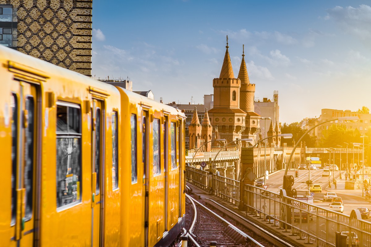 Yellow Berlin U-Bahn train on the Oberbaum Bridge at sunset