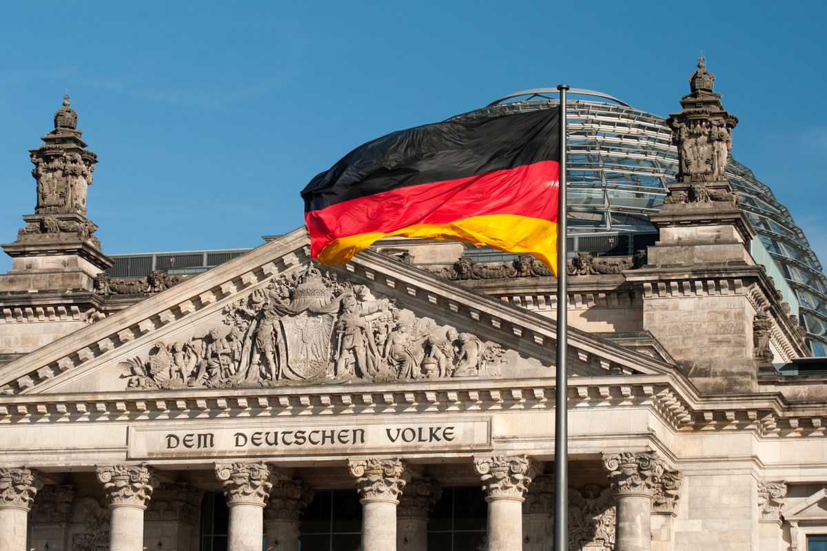 German flag flying above the Reichstag building in Berlin