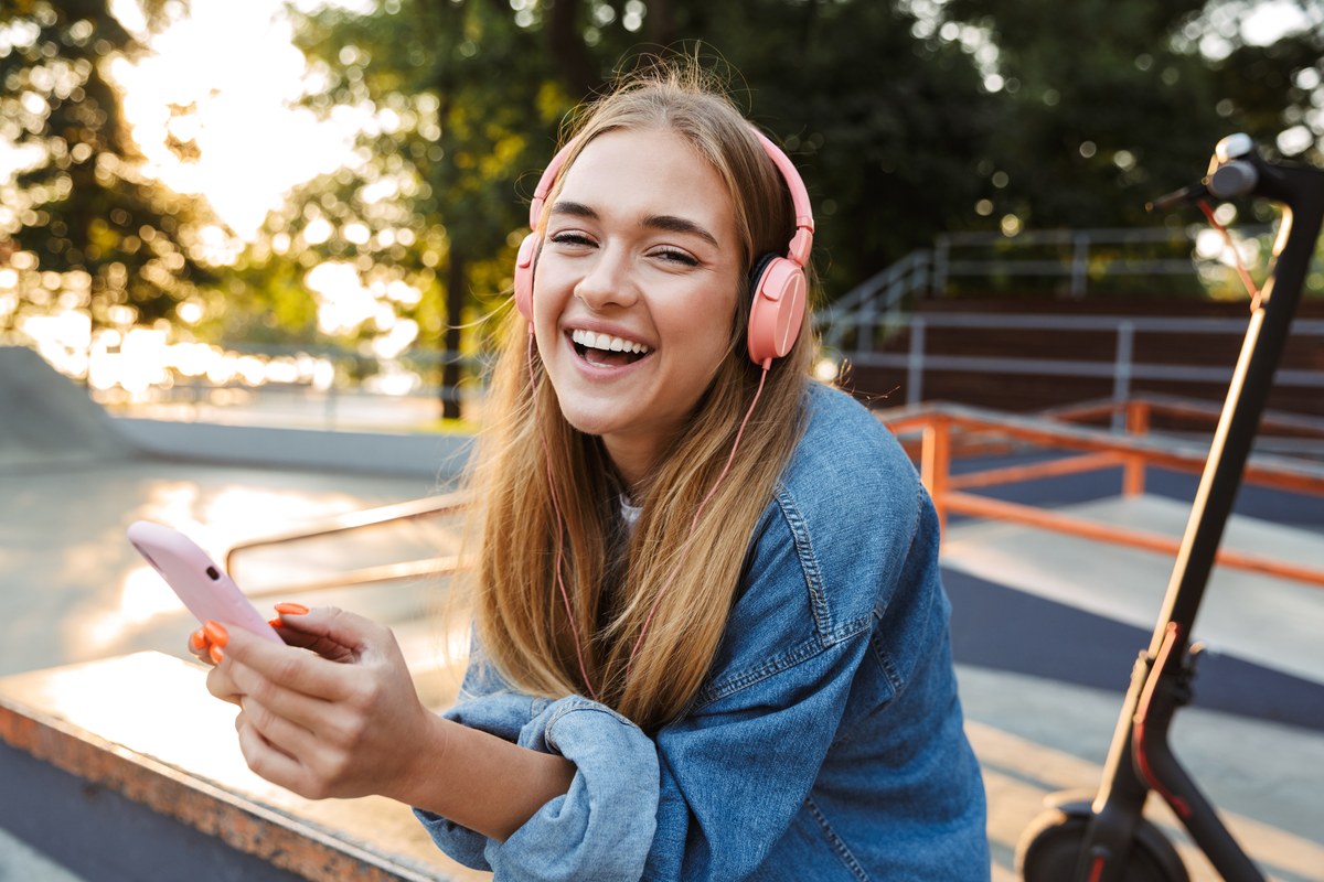Laughing woman looking at her phone