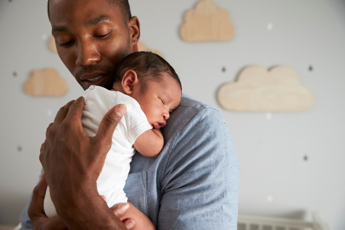 Father holding his sleeping baby