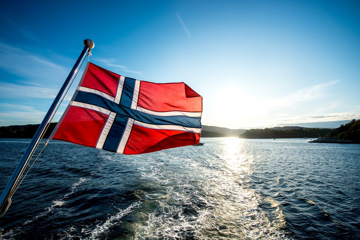 The Norwegian flag flying over the sea