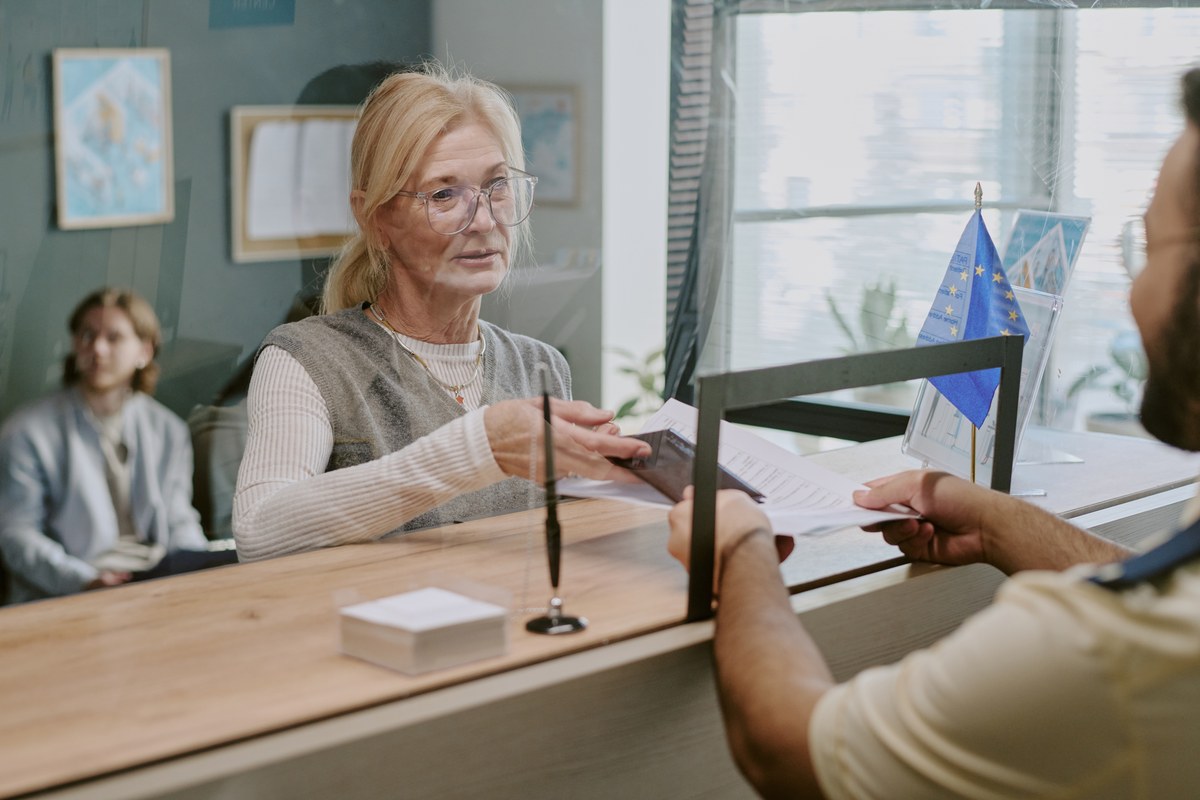 Woman helping a customer at an office counter