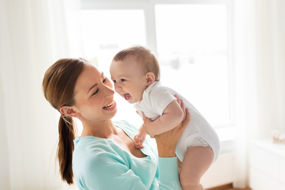 Mother holding her smiling baby