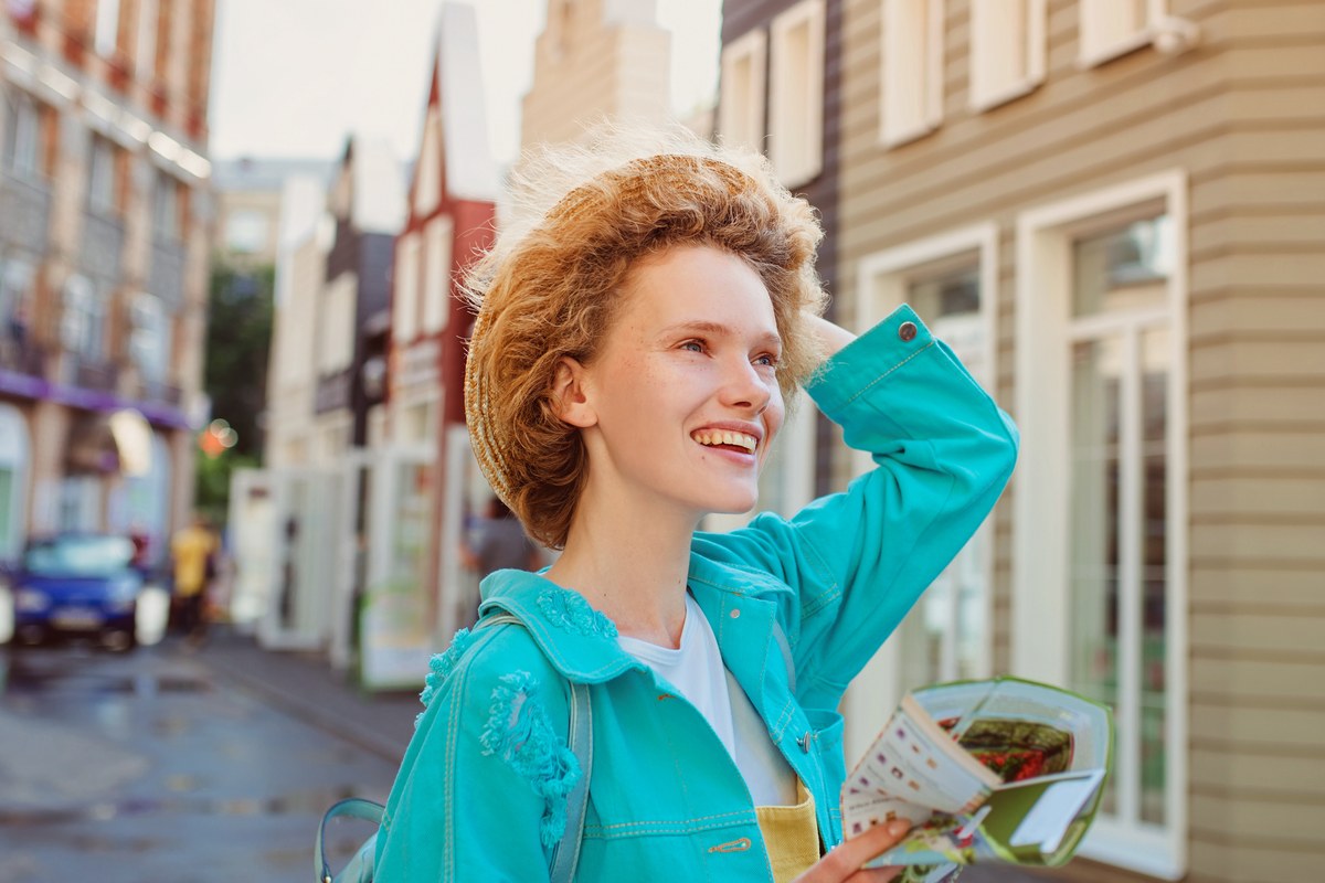 Young woman with a map arriving in a new city