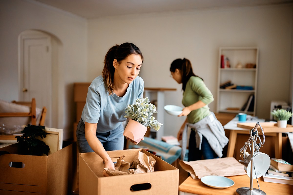 Woman unpacking boxes in her new home
