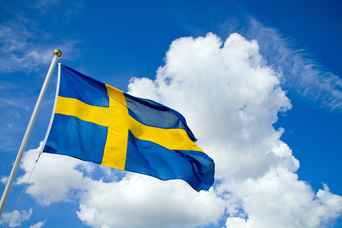 The Swedish flag against a blue sky