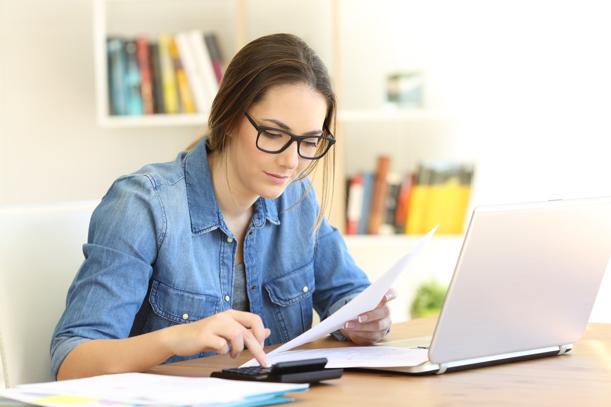 Woman going through bills and taxes at home