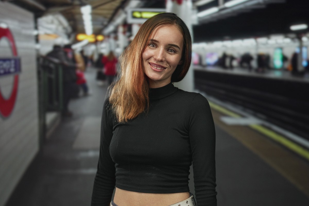 Smiling woman standing on a London Underground platform
