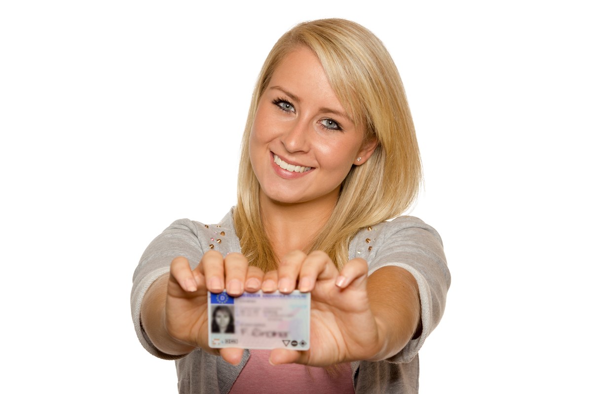 Woman holding up her ID card