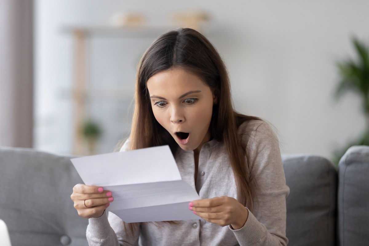 Woman reading a surprising letter