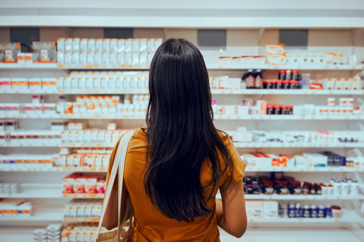 Woman choosing medicine in a pharmacy